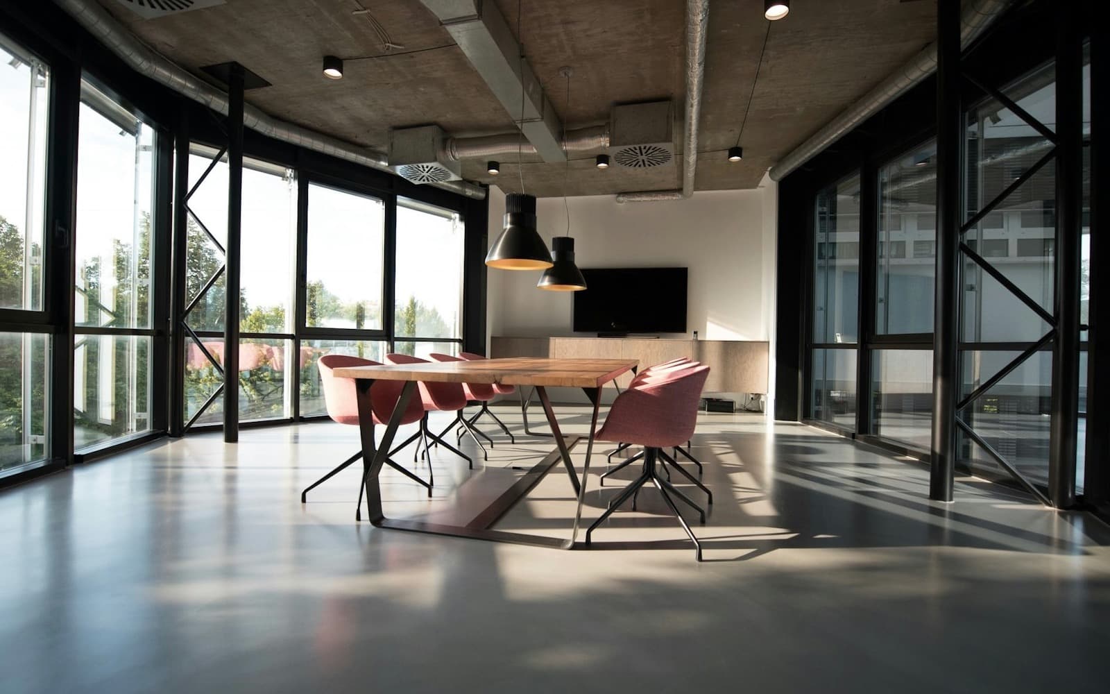 A quiet modern meeting room with a large table and natural light